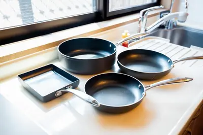 two frying pans sitting on a counter next to a sink at Premier suite Shinjuku okubo Tokyo 3F in Tokyo