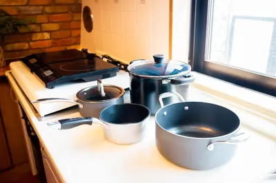 three pots and pans sitting on a kitchen counter at Premier suite Shinjuku okubo Tokyo 3F in Tokyo