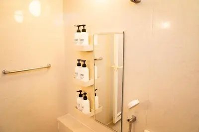 a bathroom with a shower with a mirror and a sink at Premier suite Shinjuku okubo Tokyo 3F in Tokyo