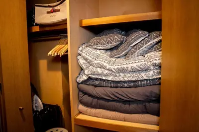 a stack of sleeping bags in a closet at Premier suite Shinjuku okubo Tokyo 3F in Tokyo