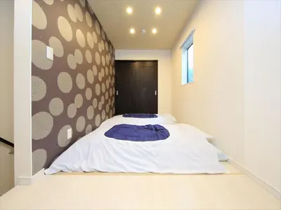 a bed in a room with a wall at COTO Tokyo Shibuya 8 in Tokyo