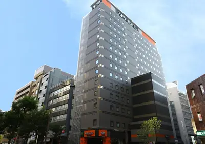 a tall building with a sign on top of it at APA Hotel Omori Ekimae in Tokyo