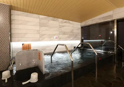 a bathroom with a hot tub with water in it at APA Hotel Omori Ekimae in Tokyo