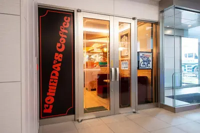 a store front with a sign on the side of a building at Wires Hotel Shinagawa Seaside in Tokyo
