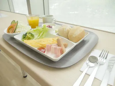 a tray with a plate of food on a table at Wires Hotel Shinagawa Seaside in Tokyo