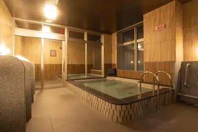 a bathroom with a hot tub in the middle at Wires Hotel Shinagawa Seaside in Tokyo