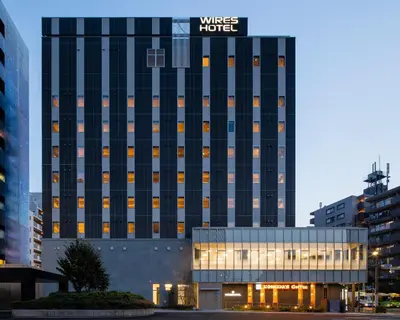 a building with a hotel sign on top of it at Wires Hotel Shinagawa Seaside in Tokyo