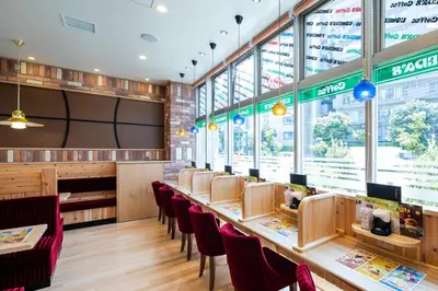 a restaurant with a long table and chairs at Wires Hotel Shinagawa Seaside in Tokyo