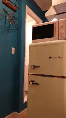a microwave on top of a refrigerator in a kitchen at \u30db\u30c6\u30eb The Standard Apartment SHIBUYA SASAZUKA B\u30eb\u30fc\u30e0 in Tokyo