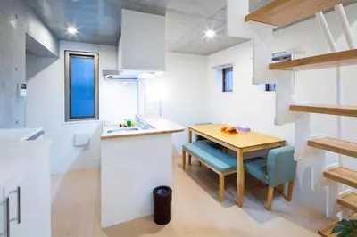 a kitchen and dining room with a table and chairs at Laffitte Hirai Condominium Hotel in Tokyo