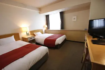 a hotel room with two beds and a flat screen tv at Hotel Abest Meguro / Vacation STAY 71402 in Tokyo