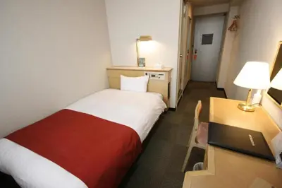 a hotel room with a bed and a desk with a laptop at Hotel Abest Meguro / Vacation STAY 71373 in Tokyo
