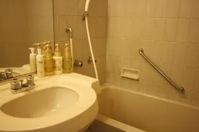 a bathroom with a toilet and a sink and a tub at Hotel Abest Meguro / Vacation STAY 71373 in Tokyo