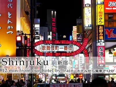 a busy city street at night with neon signs at Hotel Abest Meguro / Vacation STAY 71373 in Tokyo