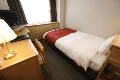 a hotel room with a bed and a desk with a lamp at Hotel Abest Meguro / Vacation STAY 71373 in Tokyo