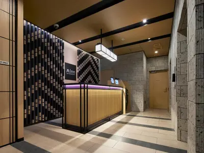 a lobby of a building with a sign on the wall at Minn Nishi Kasai in Tokyo