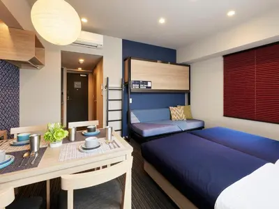 a bedroom with a bed and a desk and a desk at Minn Nishi Kasai in Tokyo