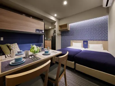 a hotel room with a bed and a dining table at Minn Nishi Kasai in Tokyo