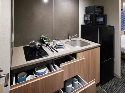 a small kitchen with a sink and a microwave at Minn Nishi Kasai in Tokyo