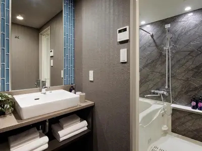 a bathroom with a sink and a shower and a tub at Minn Nishi Kasai in Tokyo