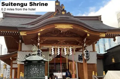 a shrine in a city with a person in front at MONday Apart Nihonbashi Ningyocho in Tokyo