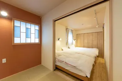 a bedroom with a large mirror reflecting a bed at VACATION INN HEIWAJIMA I in Tokyo