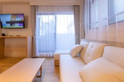 a living room with a white couch and a tv at VACATION INN HEIWAJIMA I in Tokyo