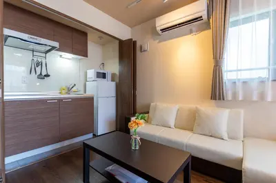 a living room with a couch and a table at VACATION INN HEIWAJIMA I in Tokyo