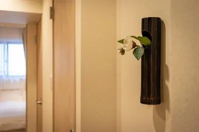 a flower on a wall next to a door at VACATION INN HEIWAJIMA I in Tokyo