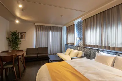 a hotel room with a bed and a table and chairs at VACATION INN HEIWAJIMA I in Tokyo
