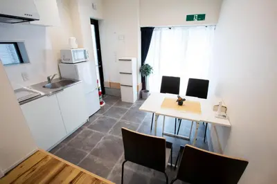 a kitchen with a table and chairs in a room at \u30b9\u30dd\u30eb\u30c8\u6771\u4eac in Tokyo