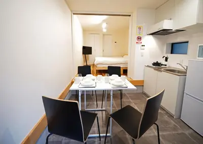 a small kitchen with a table and chairs in a room at \u30b9\u30dd\u30eb\u30c8\u6771\u4eac in Tokyo