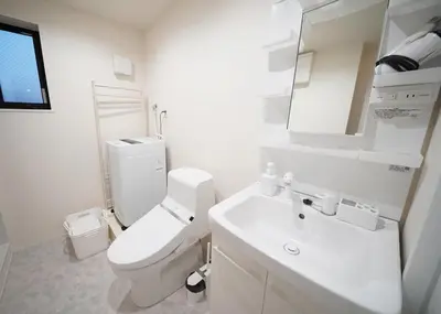 a white bathroom with a toilet and a sink at \u30b9\u30dd\u30eb\u30c8\u6771\u4eac in Tokyo