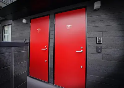 two red doors on the side of a building at \u30b9\u30dd\u30eb\u30c8\u6771\u4eac in Tokyo