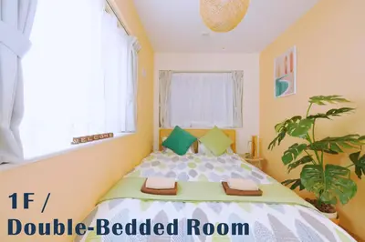 a bedroom with a bed with two towels on it at nestay villa tokyo otsuka in Tokyo