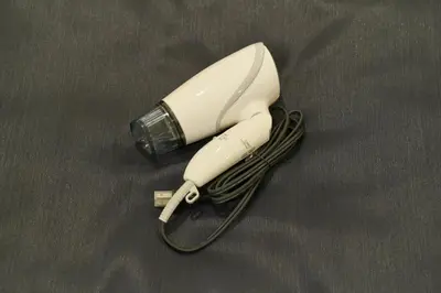 a white hair dryer sitting on a table at Ruma Inn Ikebukuro in Tokyo