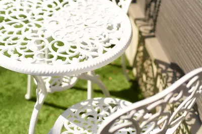 a white table and chairs on a patio at Ruma Inn Ikebukuro in Tokyo
