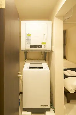 a small room with a refrigerator and a microwave at Ruma Inn Ikebukuro in Tokyo
