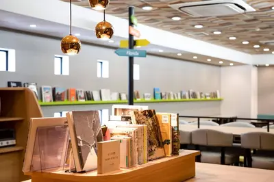 a display of books on a table in a library at Comfort Hotel Tokyo Higashi Nihombashi in Tokyo
