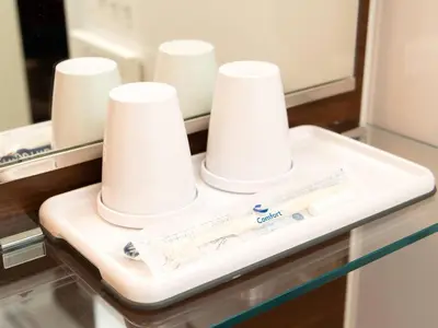 a bathroom counter with a tray with white cups on it at Comfort Hotel Tokyo Kiyosumi Shirakawa in Tokyo