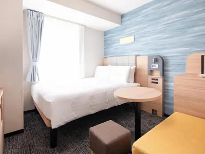 a hotel room with a bed and a table at Comfort Hotel Tokyo Kiyosumi Shirakawa in Tokyo