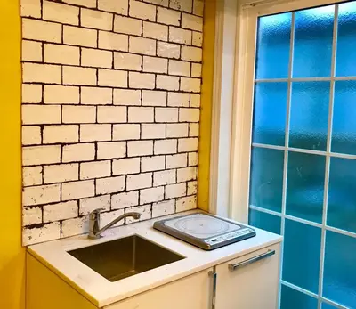 a kitchen counter with a sink and a window at \u30db\u30c6\u30eb The Standard Apartment Shibuya D 2020\u5e74\u30aa\u30fc\u30d7\u30f3 in Tokyo
