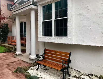 a wooden bench sitting outside of a house at \u30db\u30c6\u30eb The Standard Apartment Shibuya D 2020\u5e74\u30aa\u30fc\u30d7\u30f3 in Tokyo