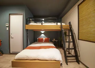 a bedroom with a bunk bed with a ladder at IKIDANE Residential Hotel Sumida Kyojima in Tokyo