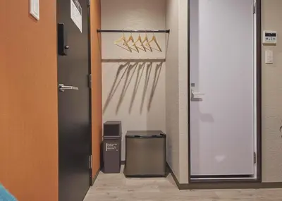 a hallway with a door with a trash can in it at IKIDANE Residential Hotel Sumida Kyojima in Tokyo