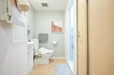 a white bathroom with a toilet and a sink at P OIN T - Shinjuku Kabukicho Designer's Apartment I in Tokyo