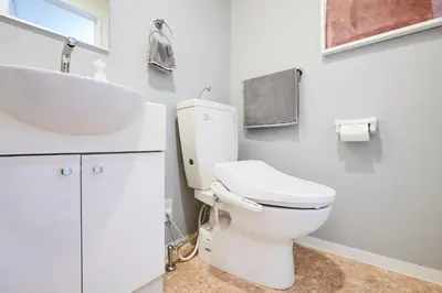 a bathroom with a white toilet and a sink at P OIN T - Shinjuku Kabukicho Designer's Apartment I in Tokyo