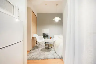 a bedroom with a white bed and a white chair at P OIN T - Shinjuku Kabukicho Designer's Apartment I in Tokyo