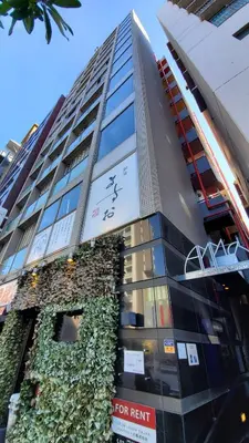 a tall building with a clock on the side of it at P OIN T - Shinjuku Kabukicho Designer's Apartment I in Tokyo