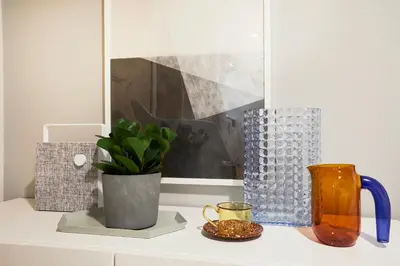 a shelf with vases and other items on it at P OIN T - Shinjuku Kabukicho Designer's Apartment I in Tokyo